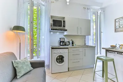 a kitchen with a washing machine and a washer at MY CASA - GROSSO 14 - 5 min walk to beach in Nice