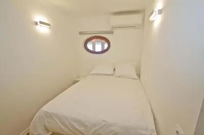 a small bedroom with a white bed with a window at PROMENADE HOLIDAY - OLD TOWN PANORAMIC in Nice