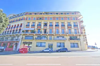 a large building with cars parked in front of it at PROMENADE HOLIDAY - OLD TOWN PANORAMIC in Nice