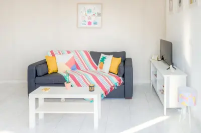 a living room with a couch and a table at #23 Henry IV Vue Panoramique Mer AC & Bright in Nice