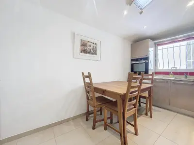 a kitchen with a wooden table and chairs at Nestor&Jeeves - MAISON COURNICHEE - Central - Close sea - Atypical in Nice