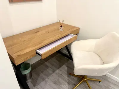 a desk with a white chair next to a table at Villa Berlioz in Nice