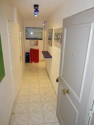 a hallway with a door and a tile floor at Vieux Nice, grand 2P sur jardins, parking, calme, soleil in Nice