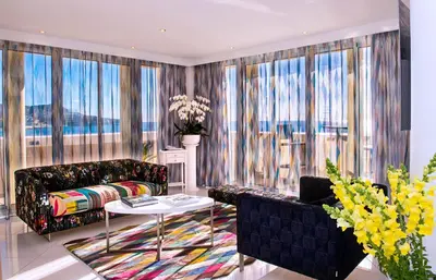 a living room with a couch and a table at Hôtel West End Promenade in Nice