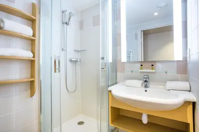 a bathroom with a sink and a shower at Hôtel Vacances Bleues Delcloy in Saint-Jean-Cap-Ferrat