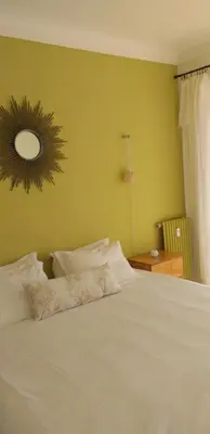 a bedroom with a white bed with a mirror on the wall at Vue mer exceptionnelle entre Nice et Monaco in Villefranche-sur-Mer