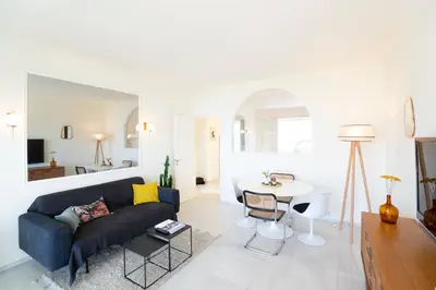 a living room with a couch and a table at Vue mer exceptionnelle entre Nice et Monaco in Villefranche-sur-Mer