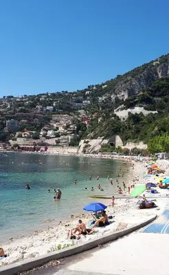 a group of people swimming in the water at a beach at Vue mer exceptionnelle entre Nice et Monaco in Villefranche-sur-Mer