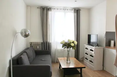a living room with a couch and a table with a tv at T2 entièrement équipé, proche toutes commodités in Nice