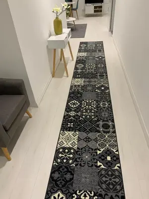 a hallway with a black and white rug on the floor at Gustave in Nice