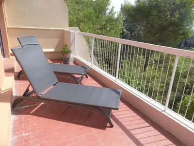 a black chair sitting on a balcony at La Madonette in Nice