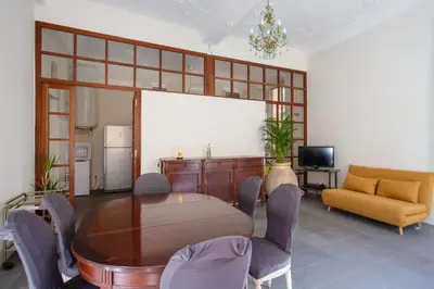 a dining room with a table and chairs and a couch at Appartement Verrière - Welkeys in Nice