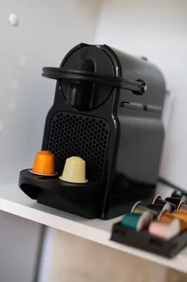 a coffee maker sitting on top of a shelf at 