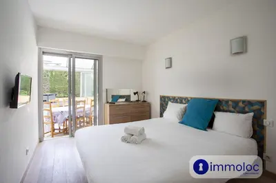 a bedroom with a bed with a teddy bear on it at Air-conditioned house with private pool in Cagnes-sur-Mer