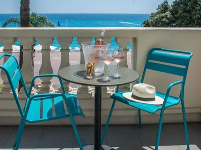 a hotel room with a bed and a chair and a television at Mercure Nice Marché Aux Fleurs in Nice