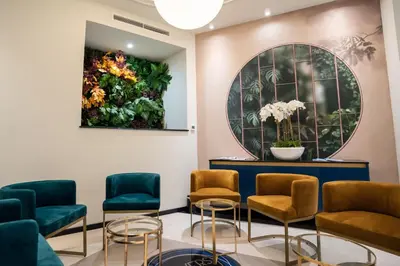 a waiting room with chairs and a painting on the wall at Hôtel Univers in Nice
