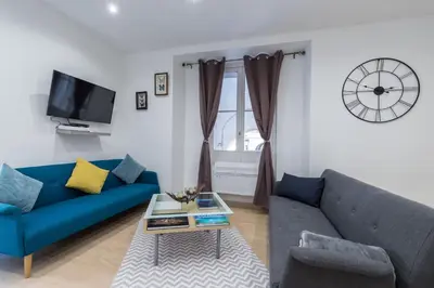 a living room with a blue couch and a table at Historical Apartment Hyper Center in Nice