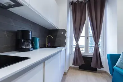 a kitchen with white counters and a window at Historical Apartment Hyper Center in Nice