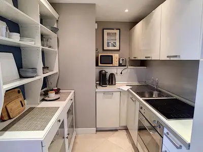 a white kitchen with white cabinets and a sink at Nestor&Jeeves - ANGEL'S BAY - City center - Close beaches in Nice