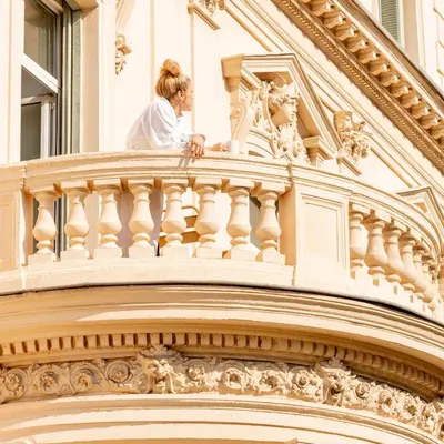 a woman standing on the top of a building at Hôtel Vendôme in Nice