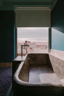 a bath tub in a bathroom with a large window at HOTEL AMOUR NICE in Nice