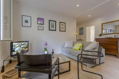 a living room with a couch and a tv at MY CASA - GAMBETTA - Charming 2 bedroom - Near Promenade in Nice