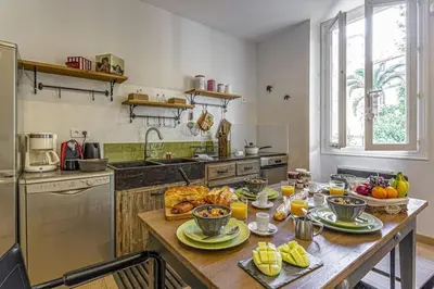 a kitchen with a table with food on it at MY CASA - GAMBETTA - Charming 2 bedroom - Near Promenade in Nice