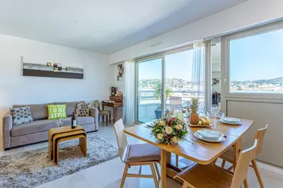 a living room with a table and a couch at MY CASA - PALAIS MED - Palais Méditerranéen - Panoramic view in Nice