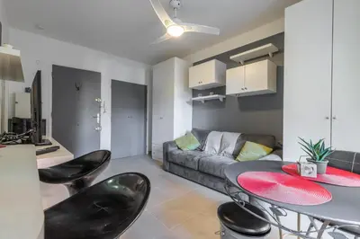 a living room with a table and chairs and a couch at Cosy Studio at Nice Port in Nice