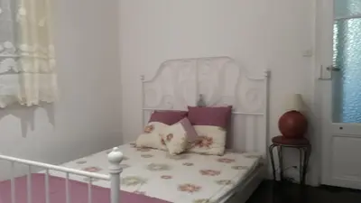 a bedroom with a bed with a white headboard and pillows at Les Palmiers NiceAirport, Beach200m, 2bedrooms, Wifi Optic in Nice