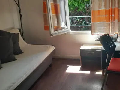 a bedroom with a bed and a desk and a window at Les Palmiers NiceAirport, Beach200m, 2bedrooms, Wifi Optic in Nice