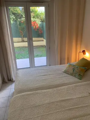 a bedroom with a bed and a large window at Villa Soraya Nice - Sunny appartment Cote d'Azur with large garden in Nice
