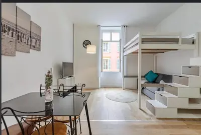 a room with a dining table and a loft bed at Jean in Nice