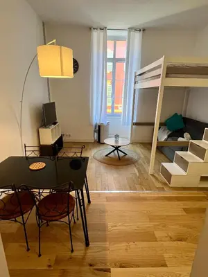 a small room with a table and a bunk bed at Jean in Nice