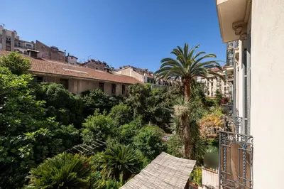 a view of a city with palm trees and buildings at MY CASA - JOFFRE 49-D - Charming 2 bedroom - Carré d'Or in Nice