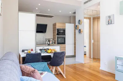 a kitchen and living room with a couch and a table at MY CASA - JOFFRE 49-D - Charming 2 bedroom - Carré d'Or in Nice