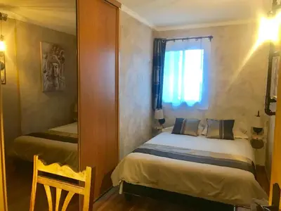 a small bedroom with two beds and a mirror at Chambres chez l'habitant Villa l'Île aux Anges in Saint-Andre-de-la-Roche