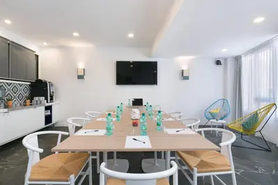 a conference room with a long table and chairs at The Deck Hotel by Happyculture in Nice