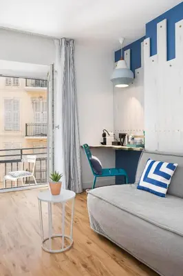 a living room with a bed and a table at The Deck Hotel by Happyculture in Nice