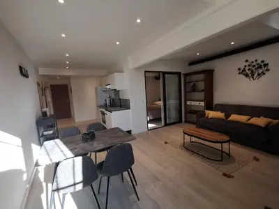 a living room with a table and a couch at Appartement Vieux Nice S in Nice