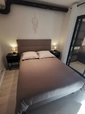 a large bed in a room with two night stands at Appartement Vieux Nice S in Nice