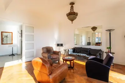 a living room with leather chairs and a couch at Ambassador Palace AP2095 by Riviera Holiday Homes in Nice
