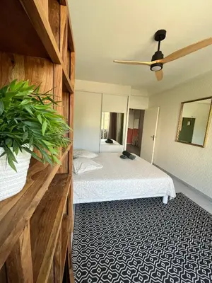 a bedroom with a bed and a ceiling fan at 2 Bedrooms - Sea View Apartment in Nice
