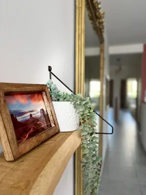 a framed picture on a wall next to a mirror at 2 Bedrooms - Sea View Apartment in Nice