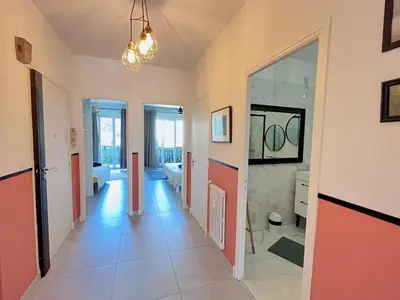 a room with a hallway with a large mirror at 2 Bedrooms - Sea View Apartment in Nice