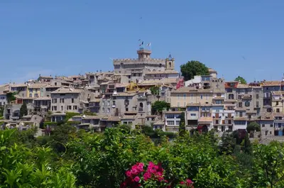a tall building with a palm tree in front of it at Studio F1 vue mer a 30m des plages in Cagnes-sur-Mer