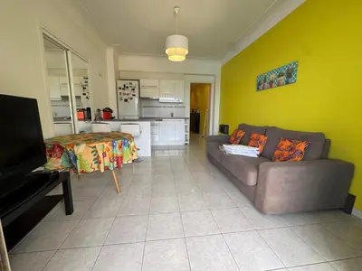 a living room with a couch and a kitchen at NEREIDES - Appartement 4 personnes avec Vue Mer exceptionnelle à Villefranche-sur-Mer in Villefranche-sur-Mer