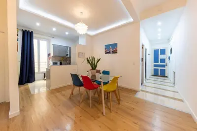 a dining room and living room with a table and chairs at The Big Flat - Hypercentre - Car park - Virtual tour in Nice