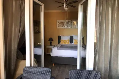 a bedroom with a bed and two chairs at Charmant appartement bord de mer, Plage in Cagnes-sur-Mer