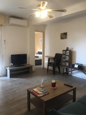 a living room with a tv and a coffee table at Charmant appartement bord de mer, Plage in Cagnes-sur-Mer